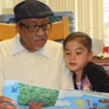 A volunteer reading to the children.