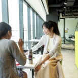 two women sitting at a table smiling and having a conversation